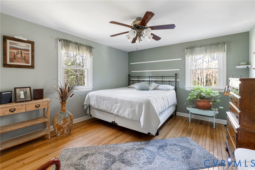 9411 Poly Place Midlothian, VA 23112 - Photo 16 of 39 a bedroom with a bed and wooden floor