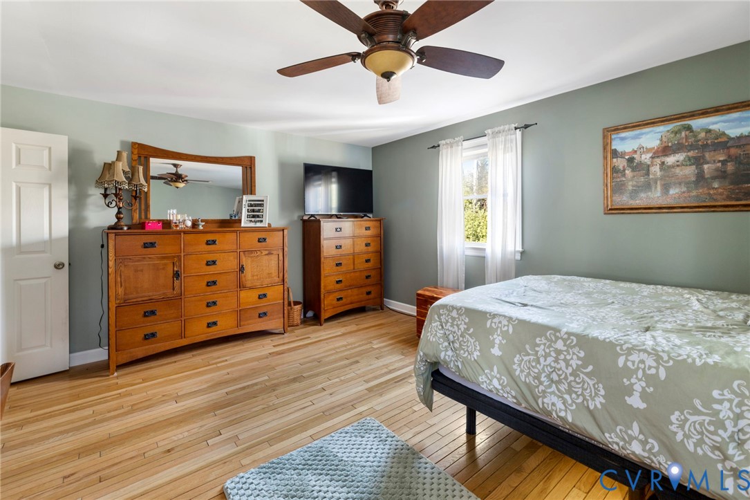 9411 Poly Place Midlothian, VA 23112 - Photo 18 of 39 a bedroom with a bed and wooden floor