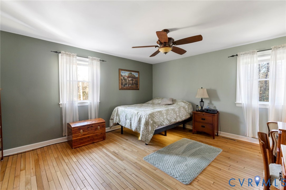 9411 Poly Place Midlothian, VA 23112 - Photo 19 of 39 a bedroom with a bed wooden floor and window