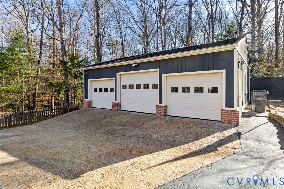 9411 Poly Place Midlothian, VA 23112 - Photo 32 of 39 a view of a house with a yard and garage