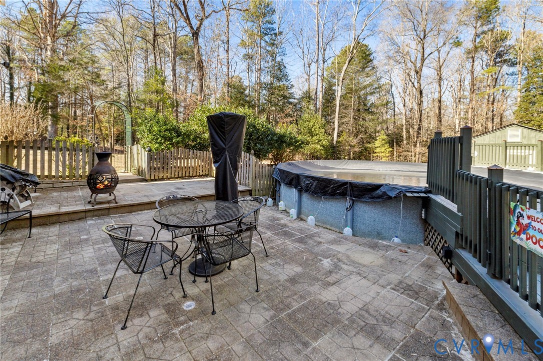9411 Poly Place Midlothian, VA 23112 - Photo 36 of 39 a view of a patio with table and chairs and potted plants