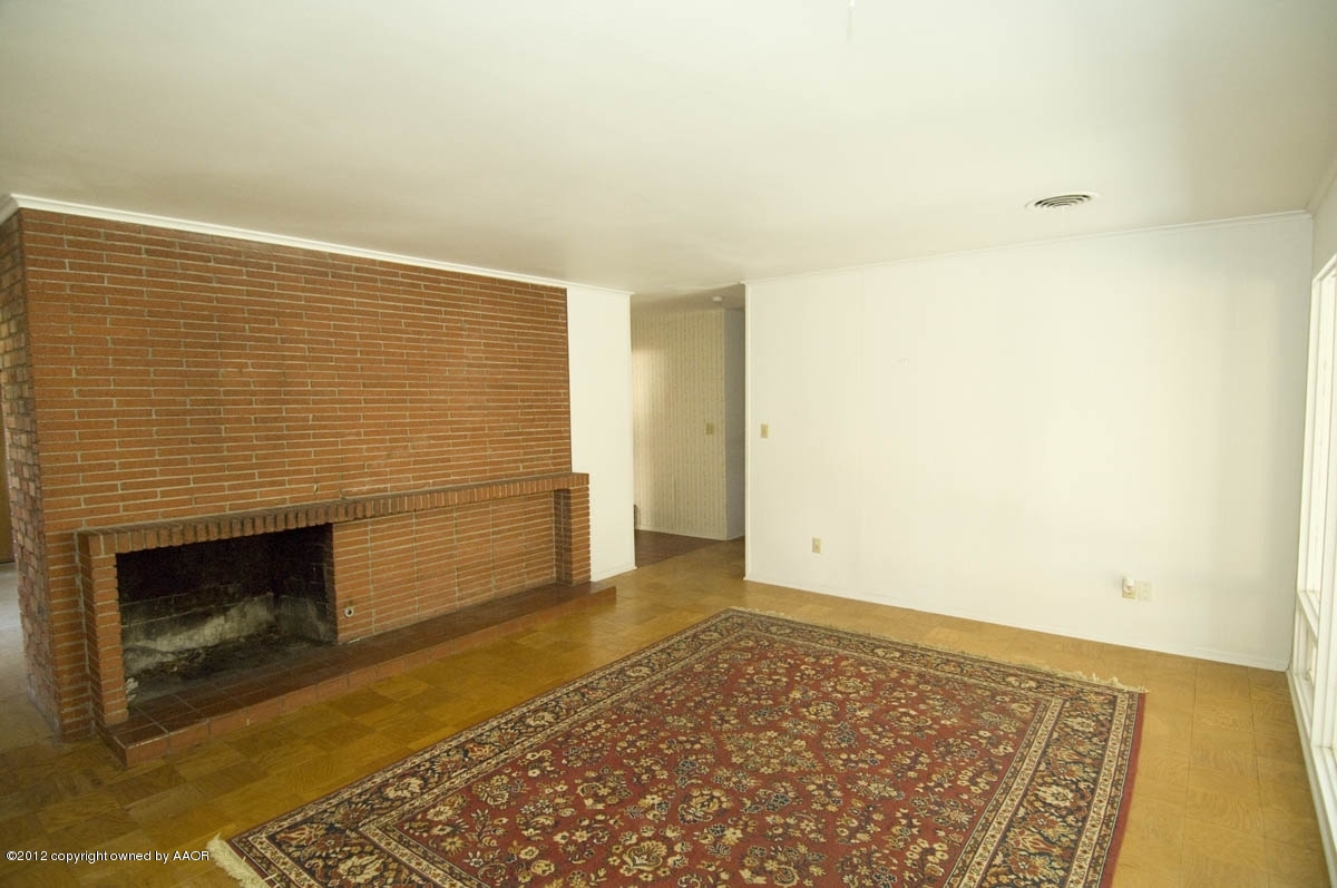 1020 South Rusk Street Amarillo, TX 79102 - Photo 7 of 32 a view of an empty room with a fireplace