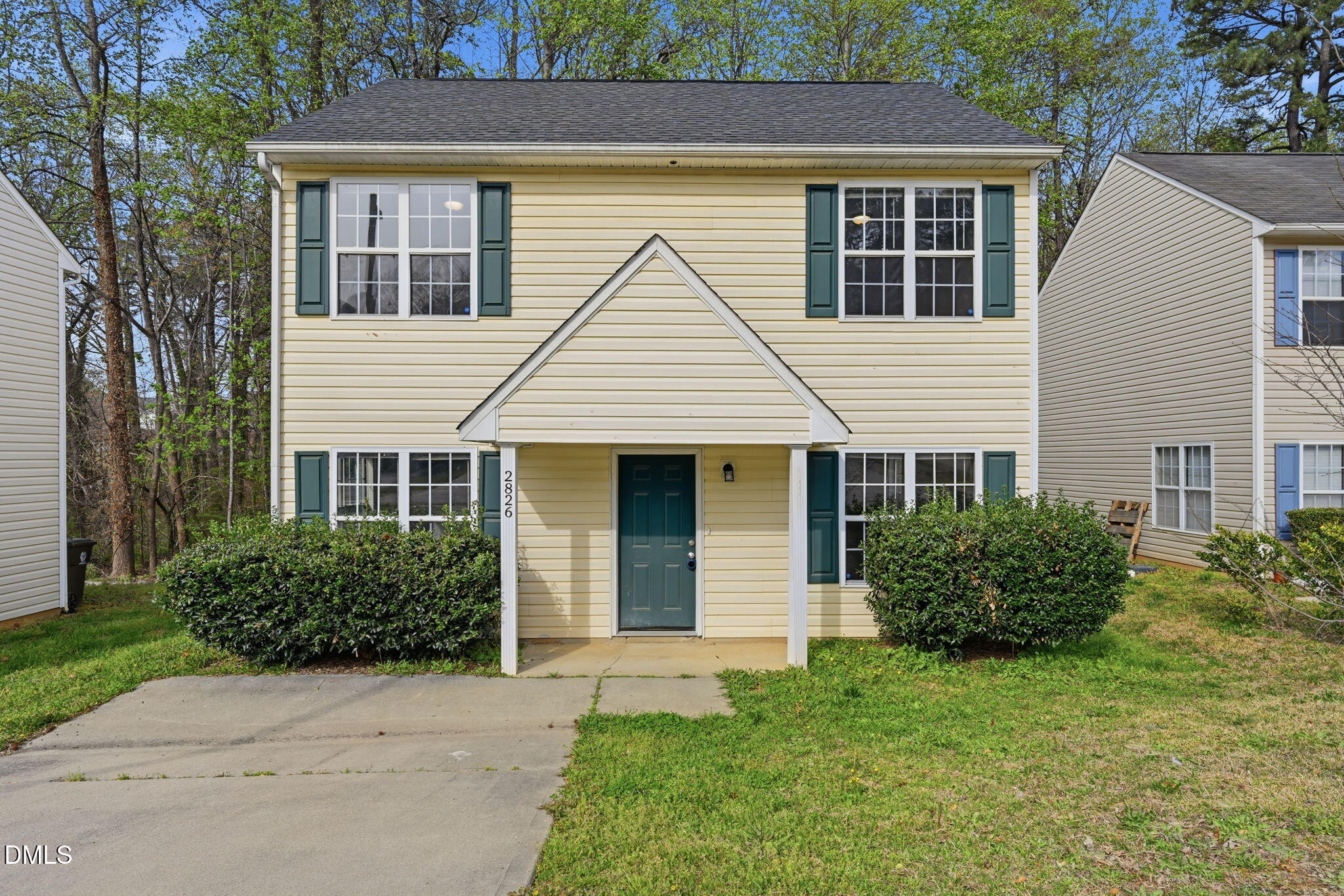 2826 Herndon Village Way Raleigh, NC 27610 - Photo 1 of 32 a view of a house with brick walls and a yard with plants