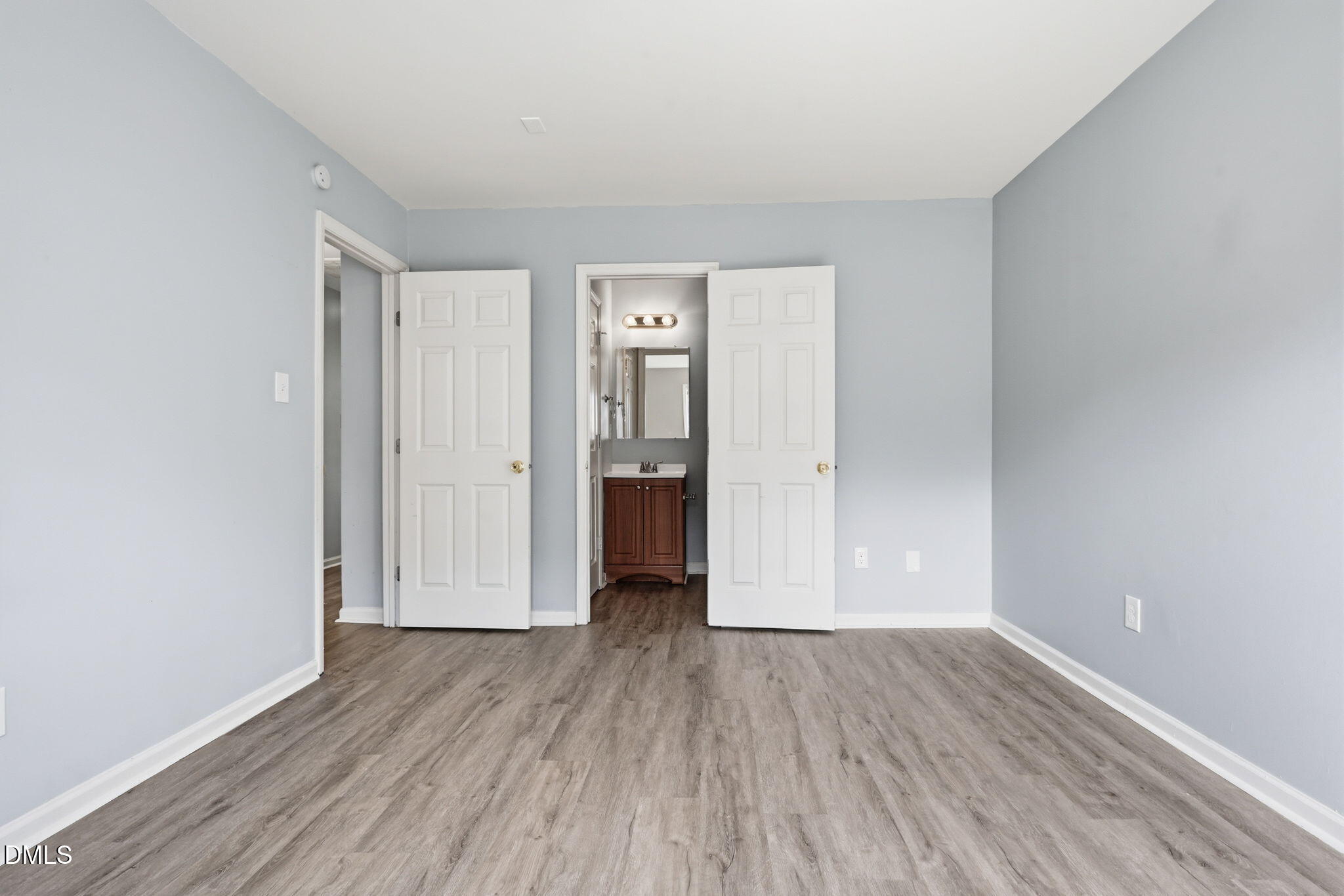 2826 Herndon Village Way Raleigh, NC 27610 - Photo 12 of 32 a view of a room with wooden floor and white doors
