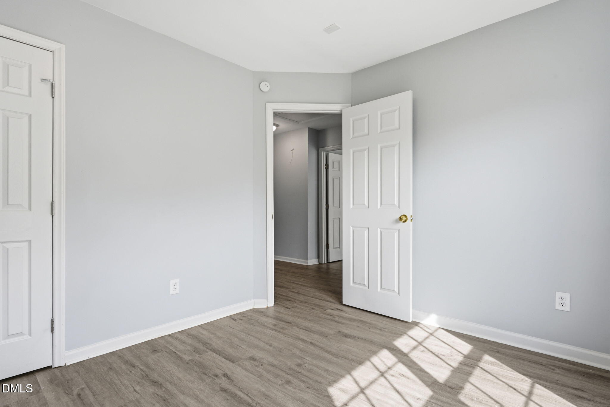 2826 Herndon Village Way Raleigh, NC 27610 - Photo 16 of 32 a view of an empty room with wooden floor