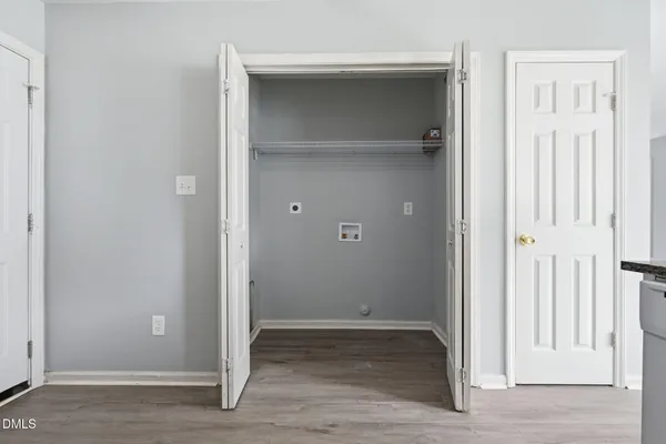 an empty room that has a wooden door