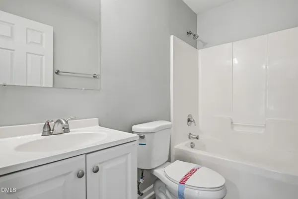 a bathroom with a sink toilet vanity and shower