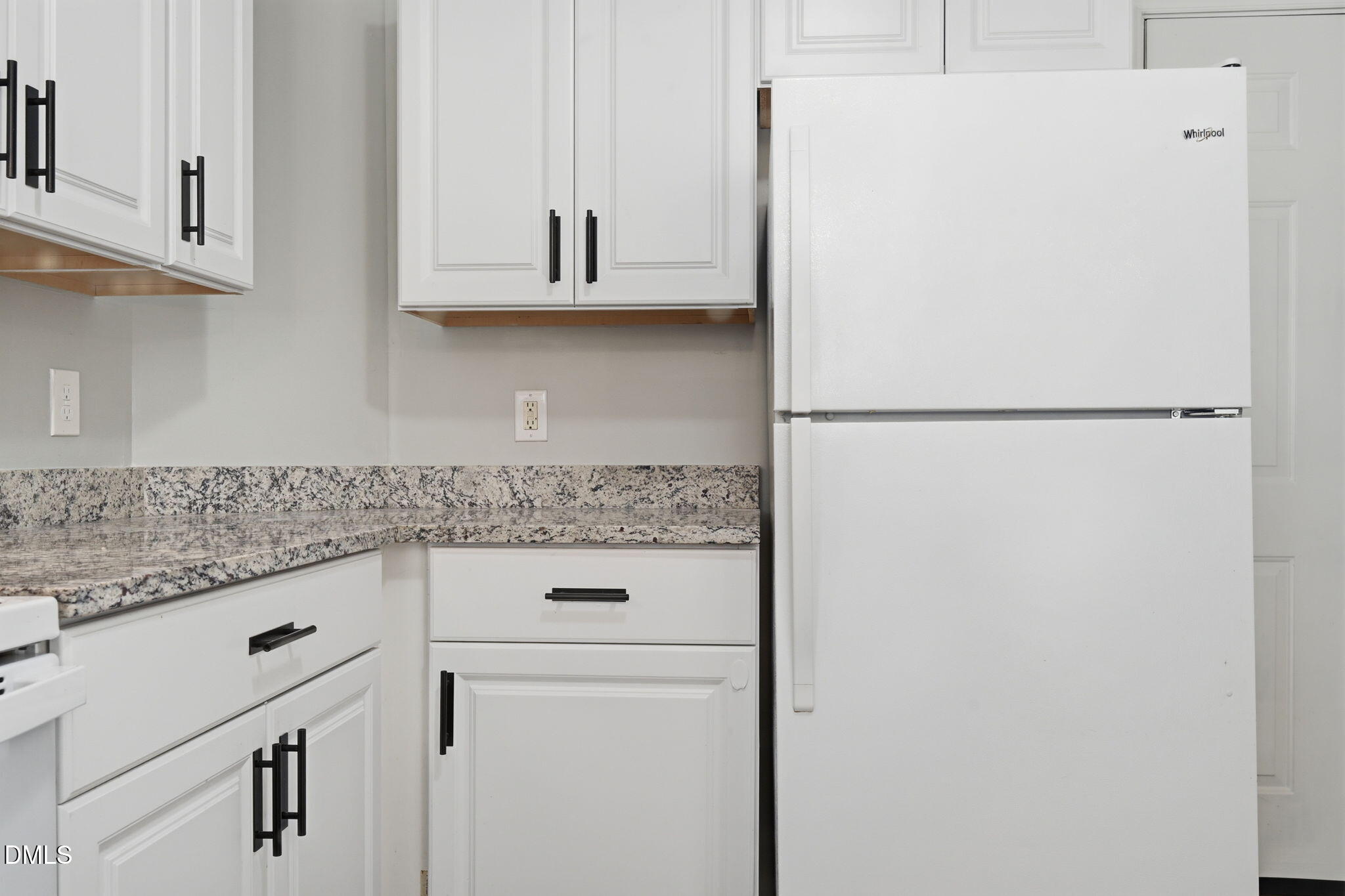2826 Herndon Village Way Raleigh, NC 27610 - Photo 9 of 32 a kitchen with white cabinets and white appliances