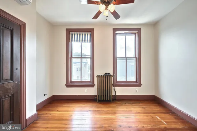 a kitchen with stainless steel appliances granite countertop a refrigerator a stove and a sink with wooden floor