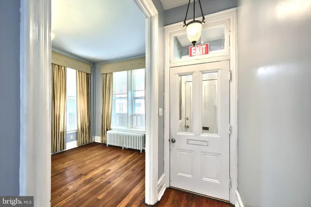 a view of staircase with wooden floor and white walls