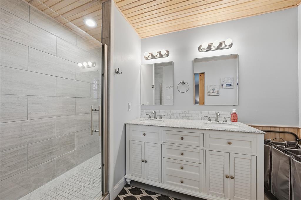 12637 Highway 19 Athens, TX 75752 - Photo 14 of 28 a bathroom with a double vanity sink a mirror and a shower