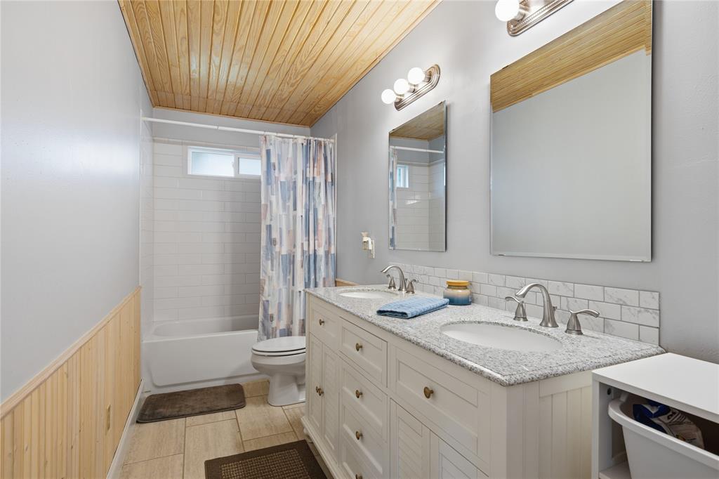 12637 Highway 19 Athens, TX 75752 - Photo 17 of 28 a bathroom with a granite countertop sink toilet and shower