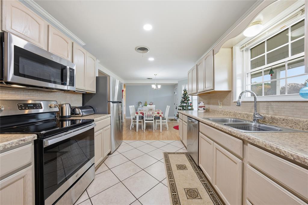 12637 Highway 19 Athens, TX 75752 - Photo 8 of 28 a kitchen with stainless steel appliances granite countertop a stove a sink and a microwave