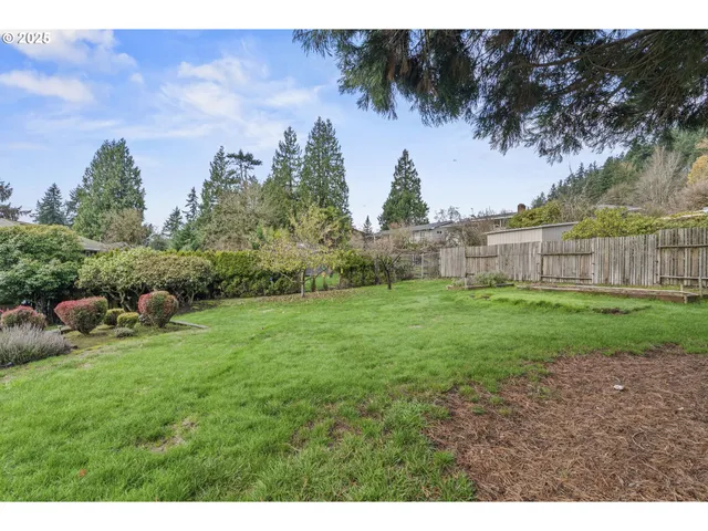 a view of a garden with a building in the background