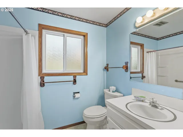 a bathroom with a sink toilet and mirror