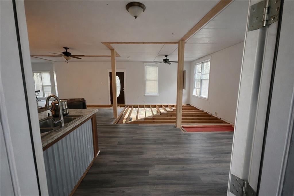 924 Highway 138 Stockbridge, GA 30281 - Photo 5 of 10 a view of a hallway view with wooden floor and staircase