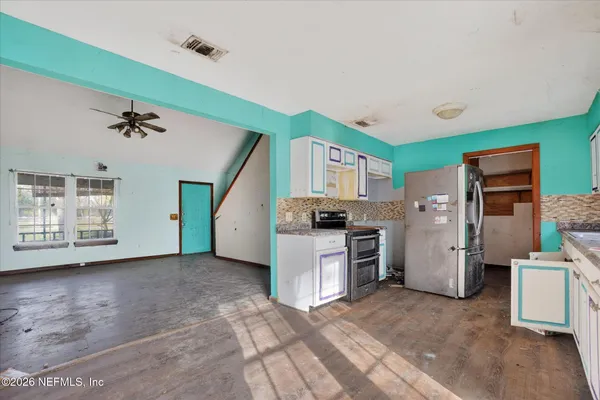 a view of a kitchen with a sink and a stove top oven