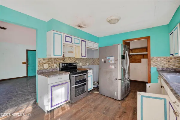 a kitchen with a refrigerator sink and stove