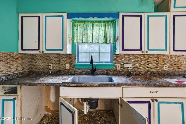 a kitchen with granite countertop a sink and a window