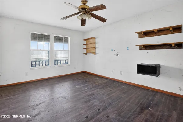 wooden floor in an empty room with a window