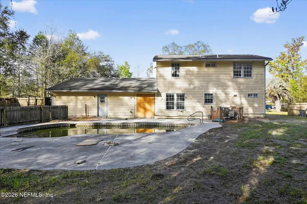 a view of a house with backyard and sitting area