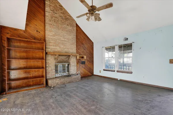 a view of an empty room with a fireplace