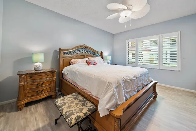 a bedroom with a bed and a flat tv screen on dresser