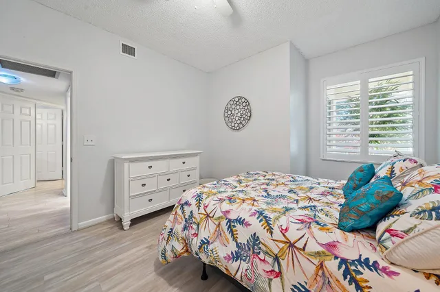 a bathroom with a granite countertop sink a toilet and a mirror