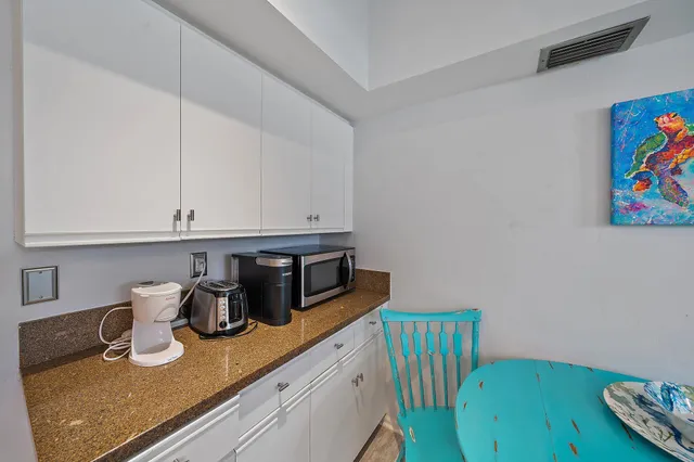 a kitchen with stainless steel appliances granite countertop a sink and a wooden cabinets