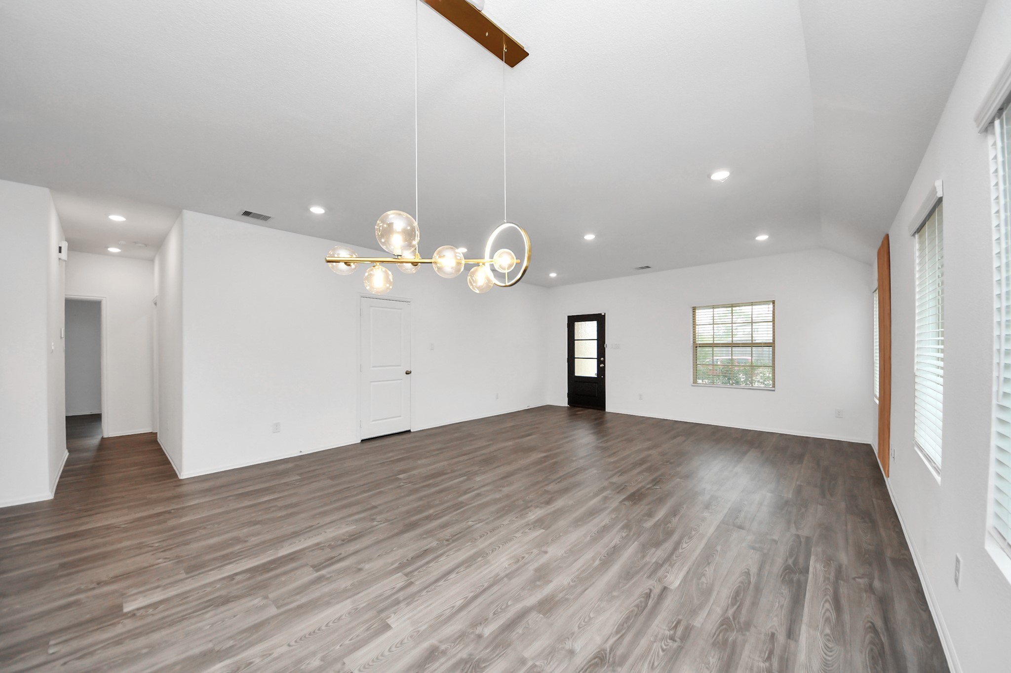 14230 Elrington Holw Trail Rosharon, TX 77583 - Photo 14 of 42 an empty room with wooden floor and windows