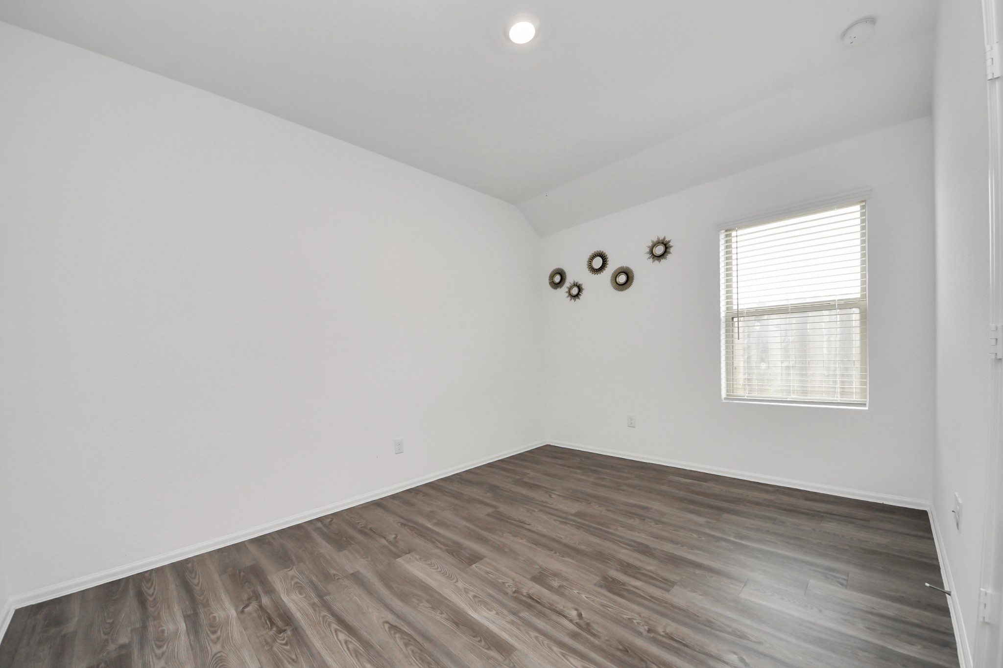 14230 Elrington Holw Trail Rosharon, TX 77583 - Photo 26 of 42 an empty room with wooden floor and windows