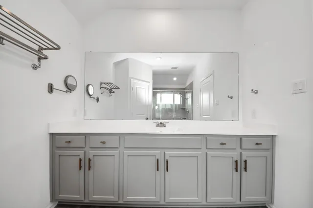 a bathroom with a granite countertop sink toilet a shower and a mirror