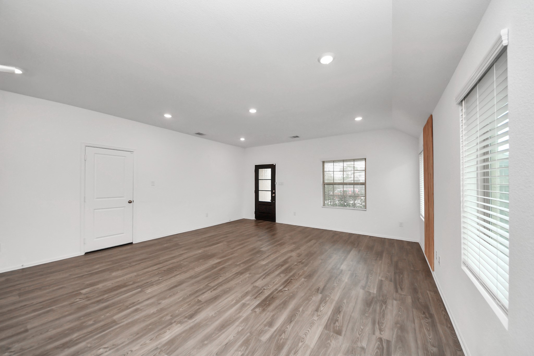 14230 Elrington Holw Trail Rosharon, TX 77583 - Photo 8 of 42 a view of an empty room with wooden floor and a window