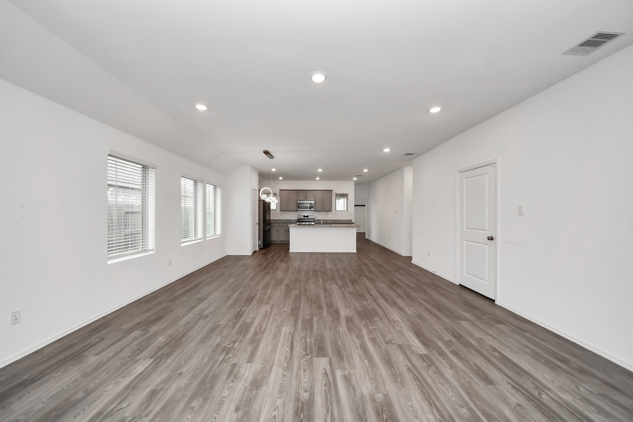 14230 Elrington Holw Trail Rosharon, TX 77583 - Photo 10 of 42 a view of an empty room with wooden floor and a window