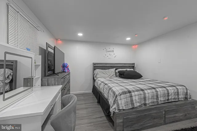 a bedroom with a bed and a large mirror