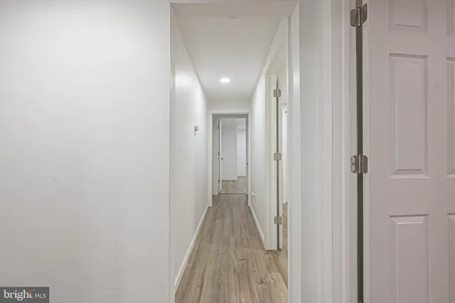 a view of a hallway with wooden floor