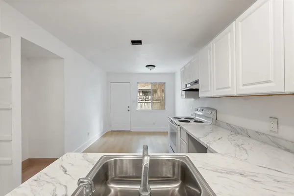 a kitchen with a sink and cabinets