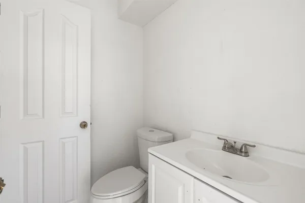 a bathroom with a sink toilet and vanity