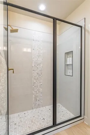 a bathroom with a glass shower door