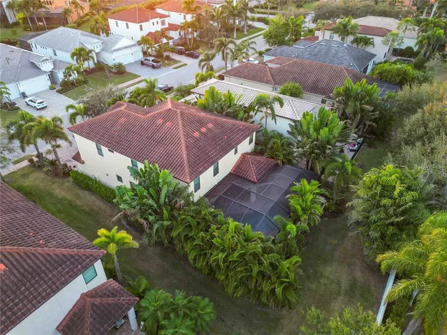 an aerial view of a house with garden space and a street view