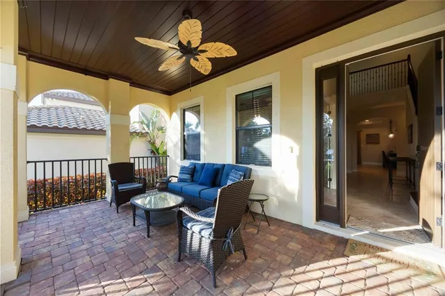 a living room with furniture a chandelier and a large window