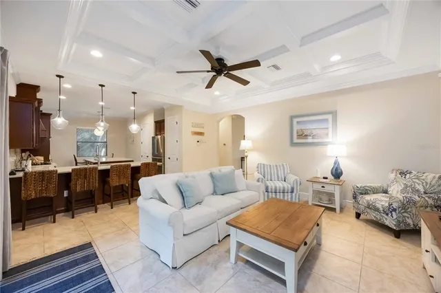 a living room with furniture kitchen view and a table