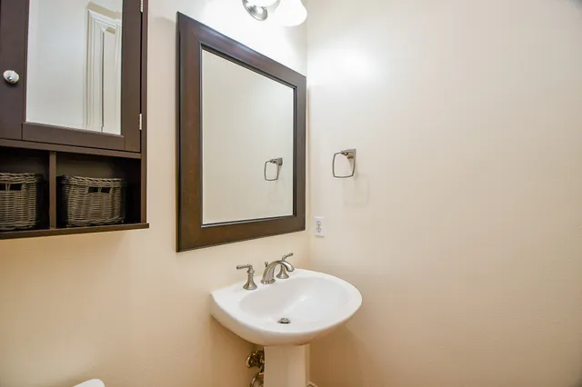 a bathroom with a sink and a mirror
