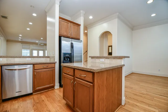 a kitchen with granite countertop a sink and a refrigerator