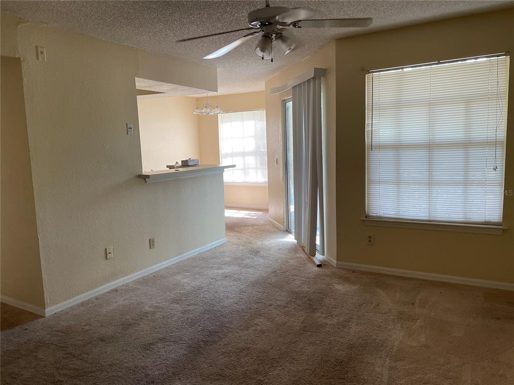 1021 South Hiawassee Road, Unit 3914 Orlando, FL 32835 - Photo 2 of 6 an empty room with windows and cabinet