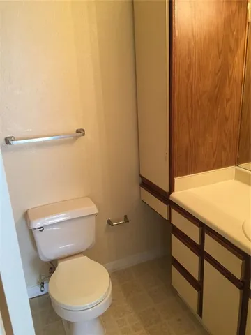a white toilet sitting next to a sink