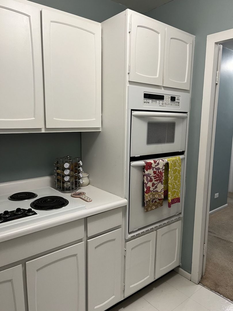 777 North Michigan Avenue, Unit 2108 Chicago, IL 60611 - Photo 15 of 38 a kitchen with stainless steel appliances granite countertop a refrigerator a stove and white cabinets