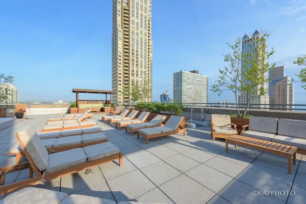 a living room with patio furniture and a potted plant