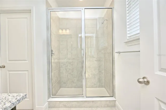 a bathroom with a glass shower door