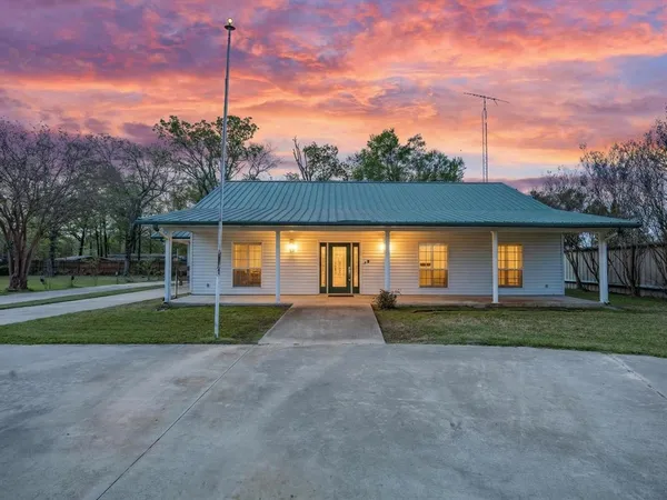 a view of a house with a yard and garage
